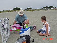 Tyler watches Dave put the kite together.