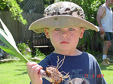 Hunter with a bulb Dave dug up while working.