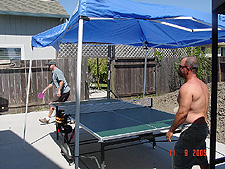 Dave and Ken play ping pong.