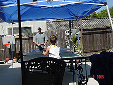 Dave plays ping pong with Tyler.