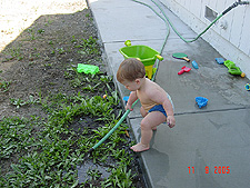 Hunter playing with the hose.