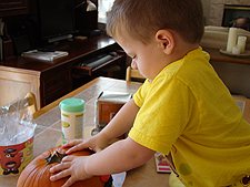 Hunter building his pumpkin.