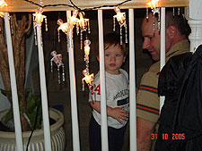 Hunter and daddy wait for trick-or-treaters.