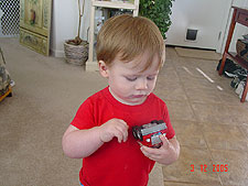 Hunter plays with his car.