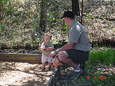 Hunter and Dave by the swingset.