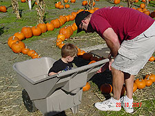 Hunter picks out a little pumpkin