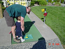 Dave helps Hunter with golf.
