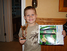 Hunter with his trophy and soccer pictures.