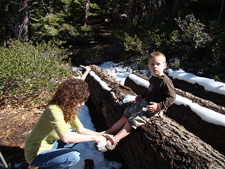 Heidi cleans Hunter's leg after he fell in the mud.