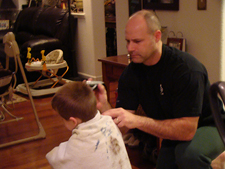 Hunter gets an after-dinner haircut from dad.