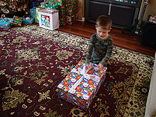 Hunter opening his gift.