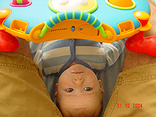 Hunter plays while Daddy holds his toy.