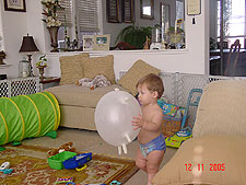 Hunter plays with his glove balloon daddy made for him.